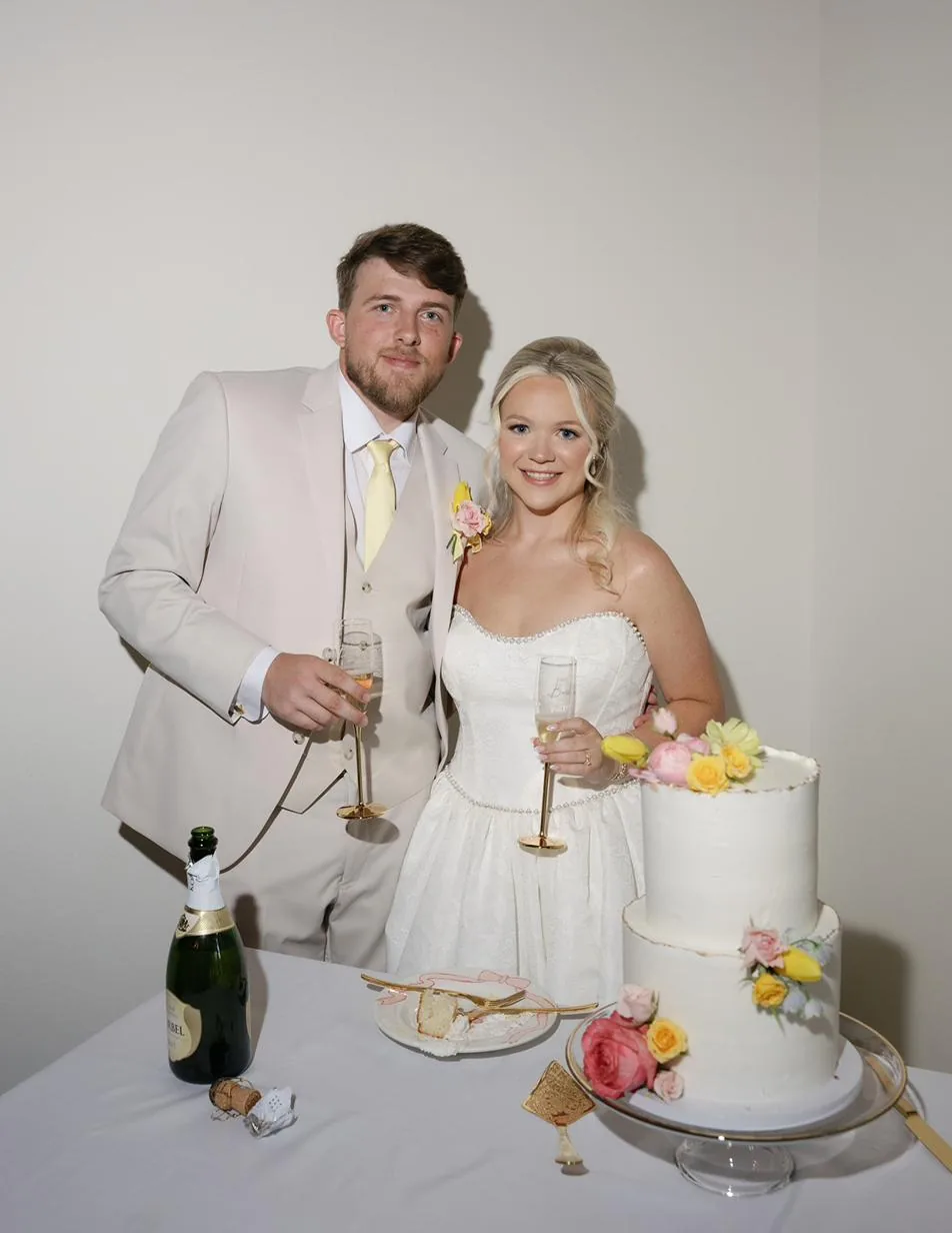 Bailey and Titus with their wedding cake at Gateley Hill Gardens