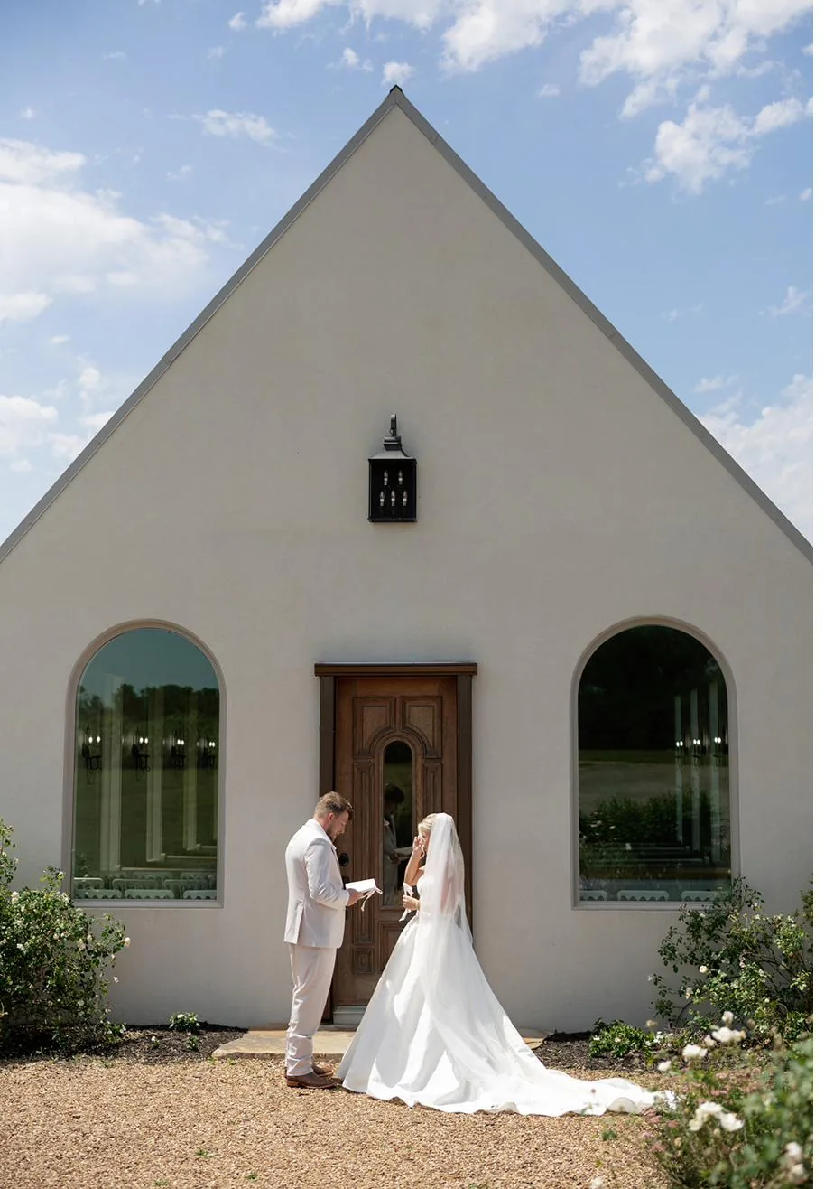Bailey and Titus outside the white stucco chapel at Gateley Hill Gardens