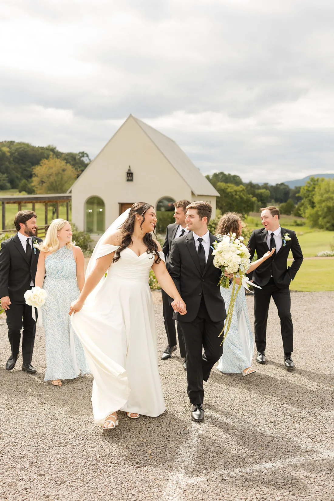 Jennifer and Hayden with their wedding party in blue at Gateley Hill Gardens