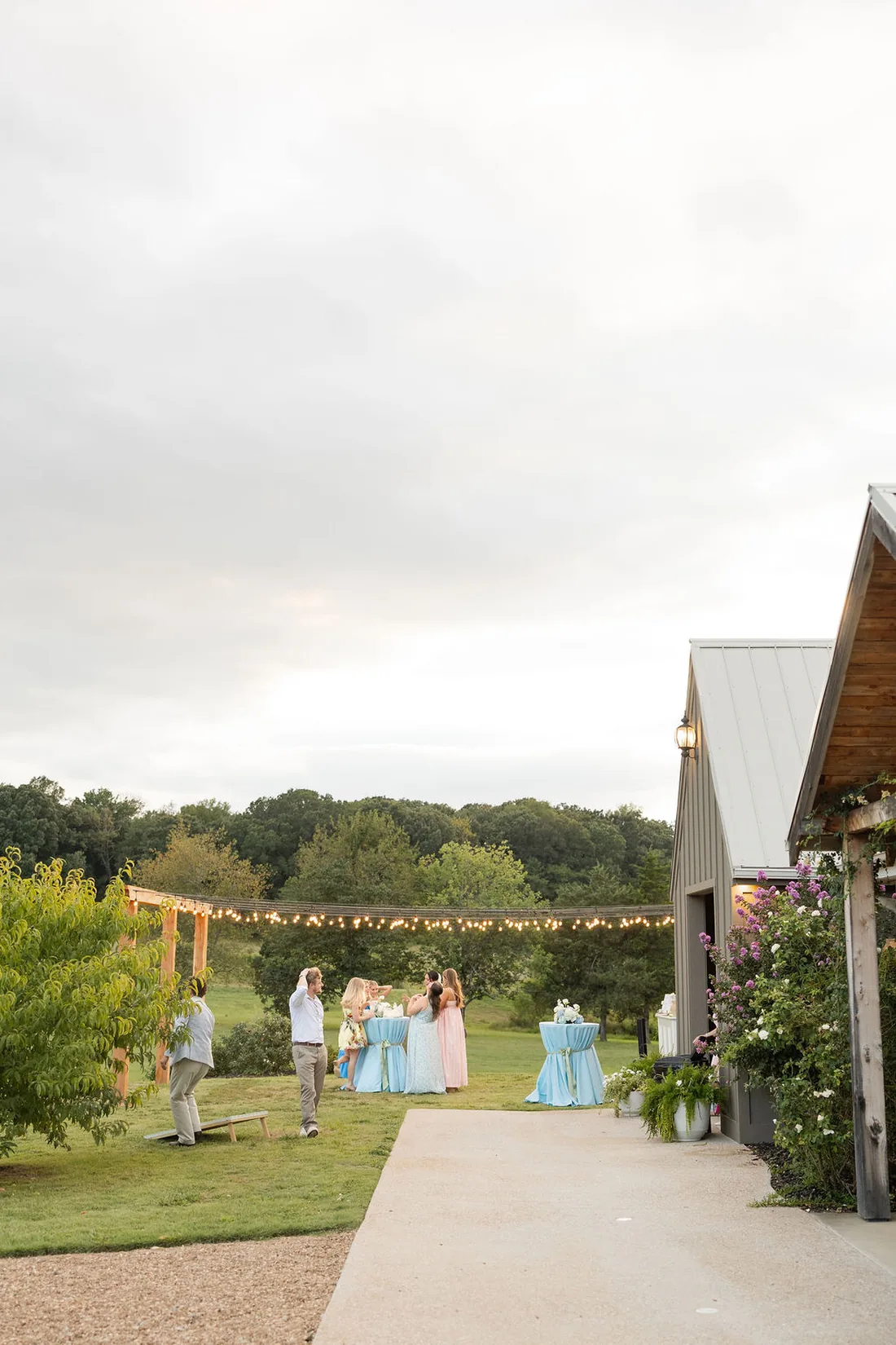 Guests gathering for the send-off under string lights at Gateley Hill Gardens