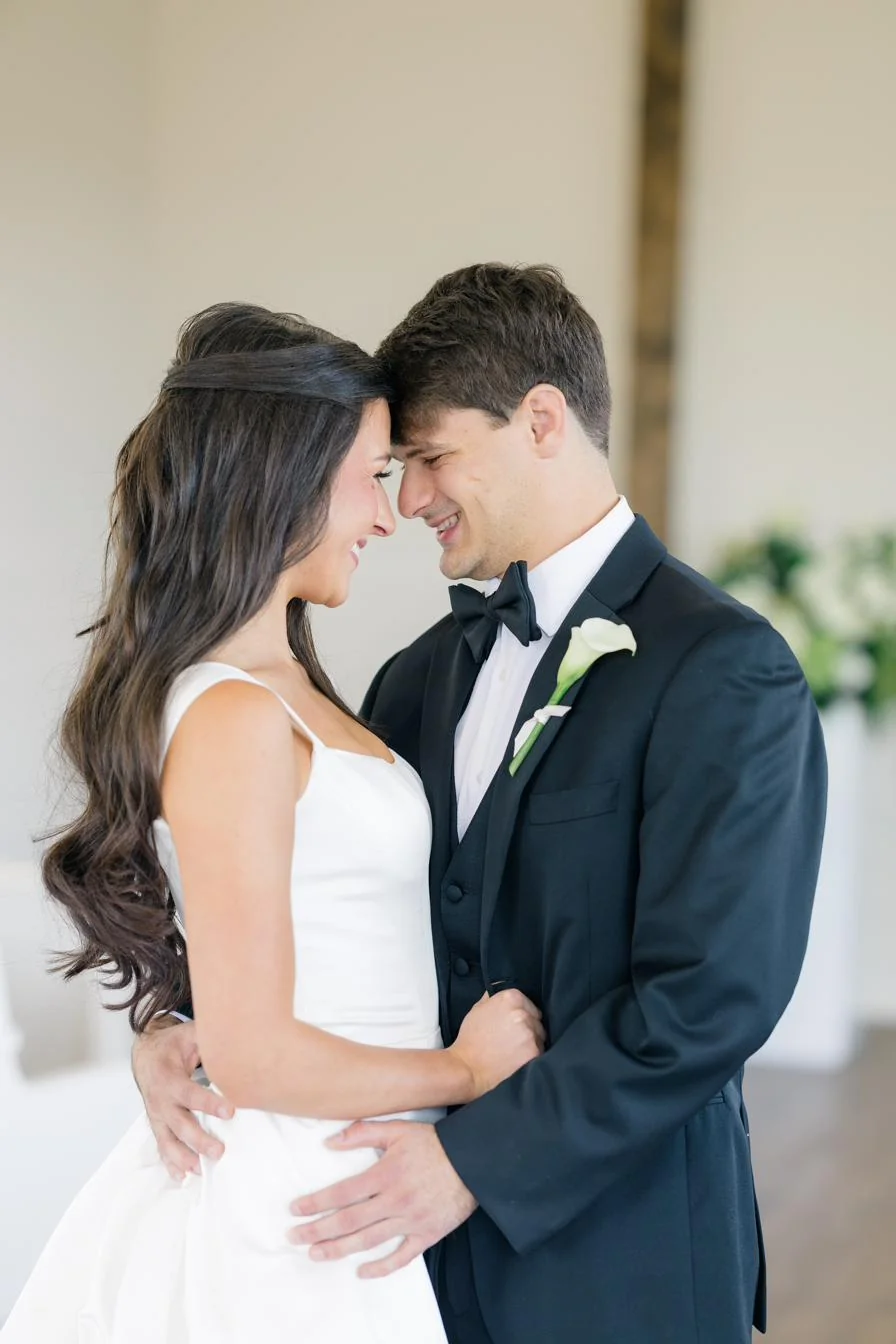 Bride and groom with the white floral installation